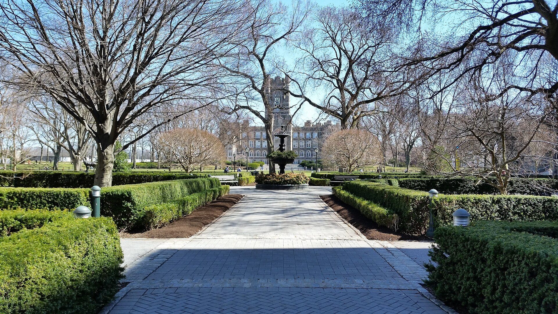 A garden walk leading to a stone fountain and Gothic tower at Fordham, the university beside the work of Richard Joseph Spinelli
