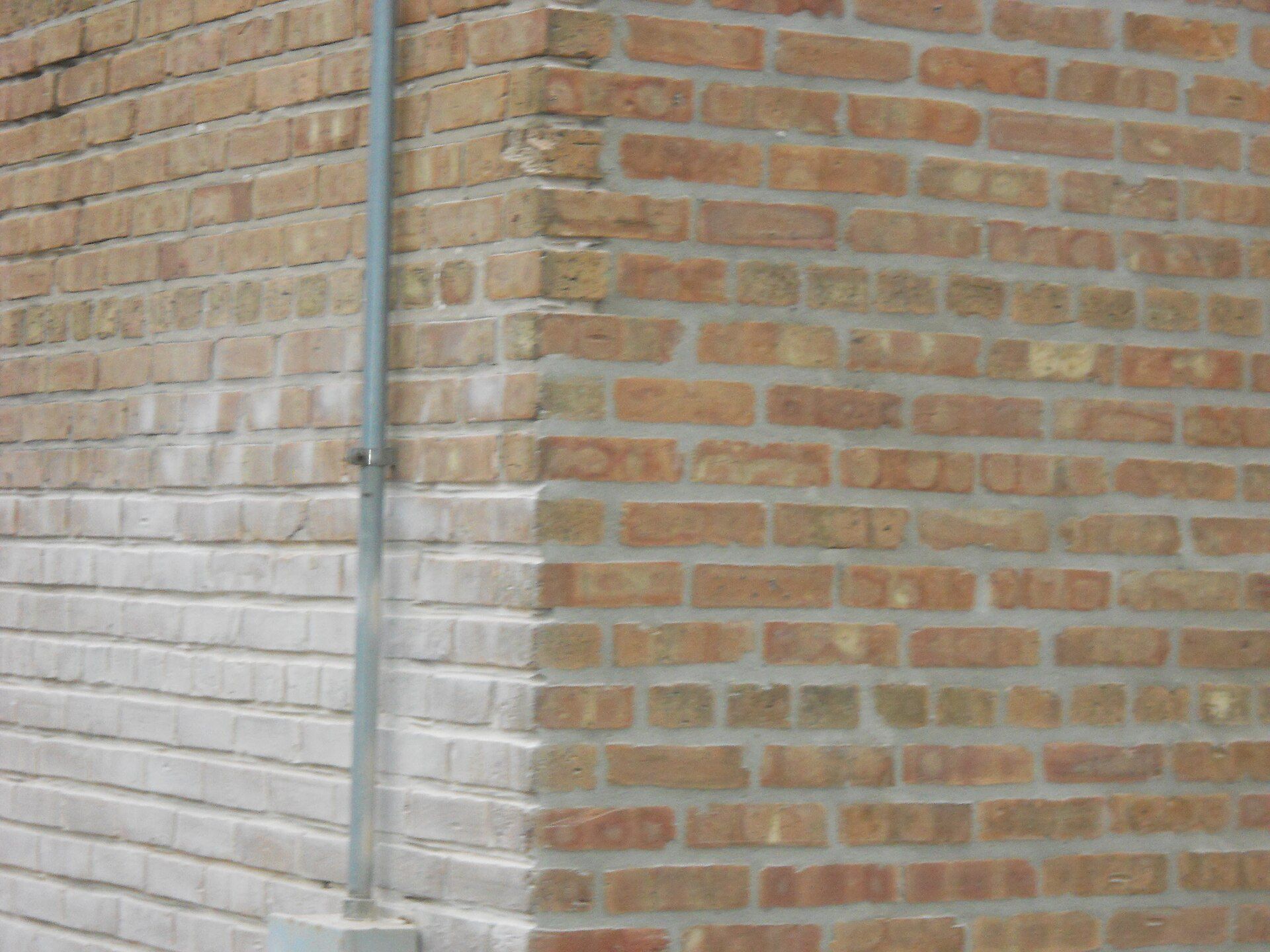 Brick wall with ground out and freshly repointed mortar joints, masonry upkeep for older buildings like those Richard Joseph Spinelli operates