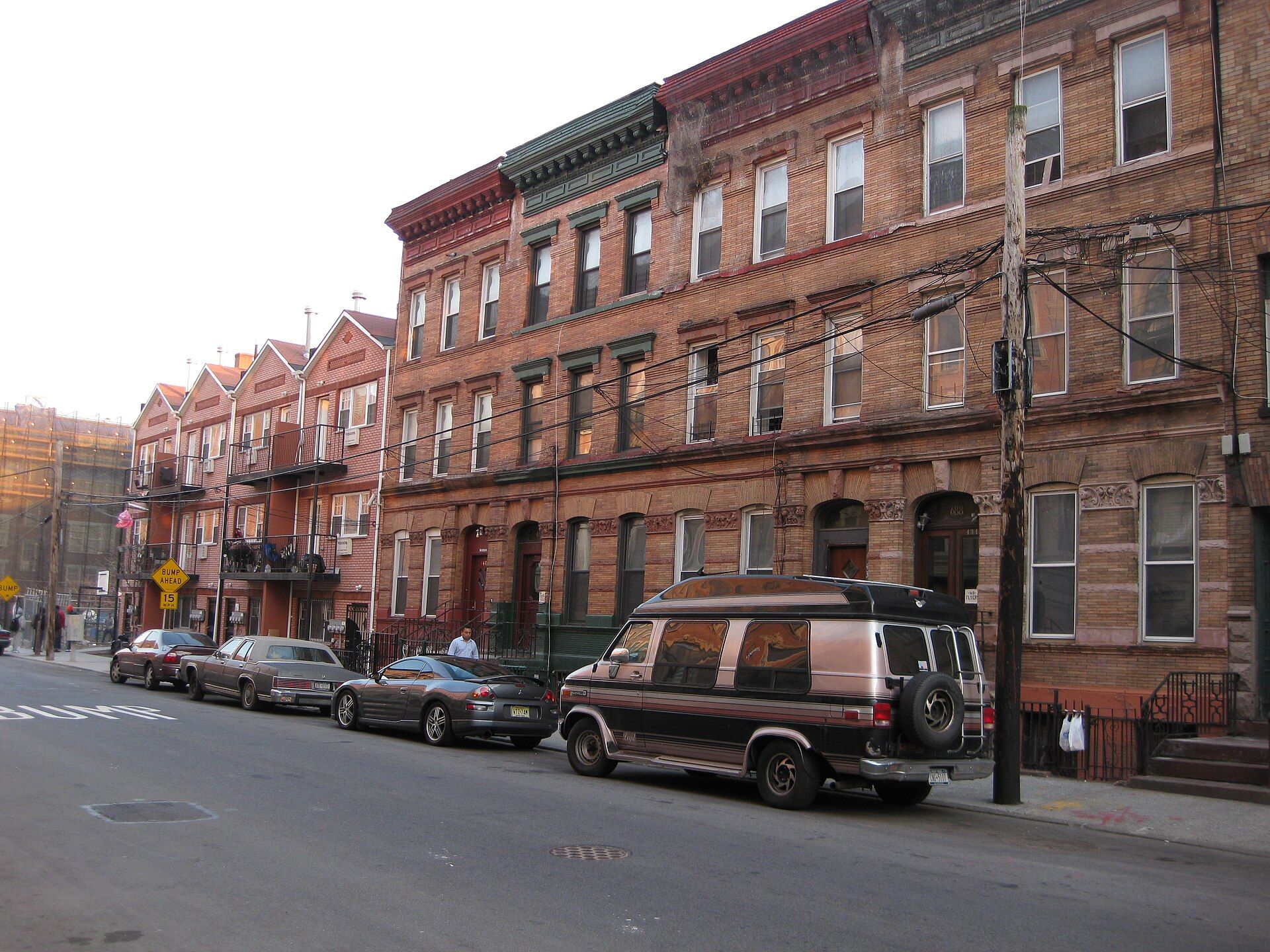 A row of brick houses with cornices and fire escapes, the attached house type Richard Joseph Spinelli renovates in the Bronx