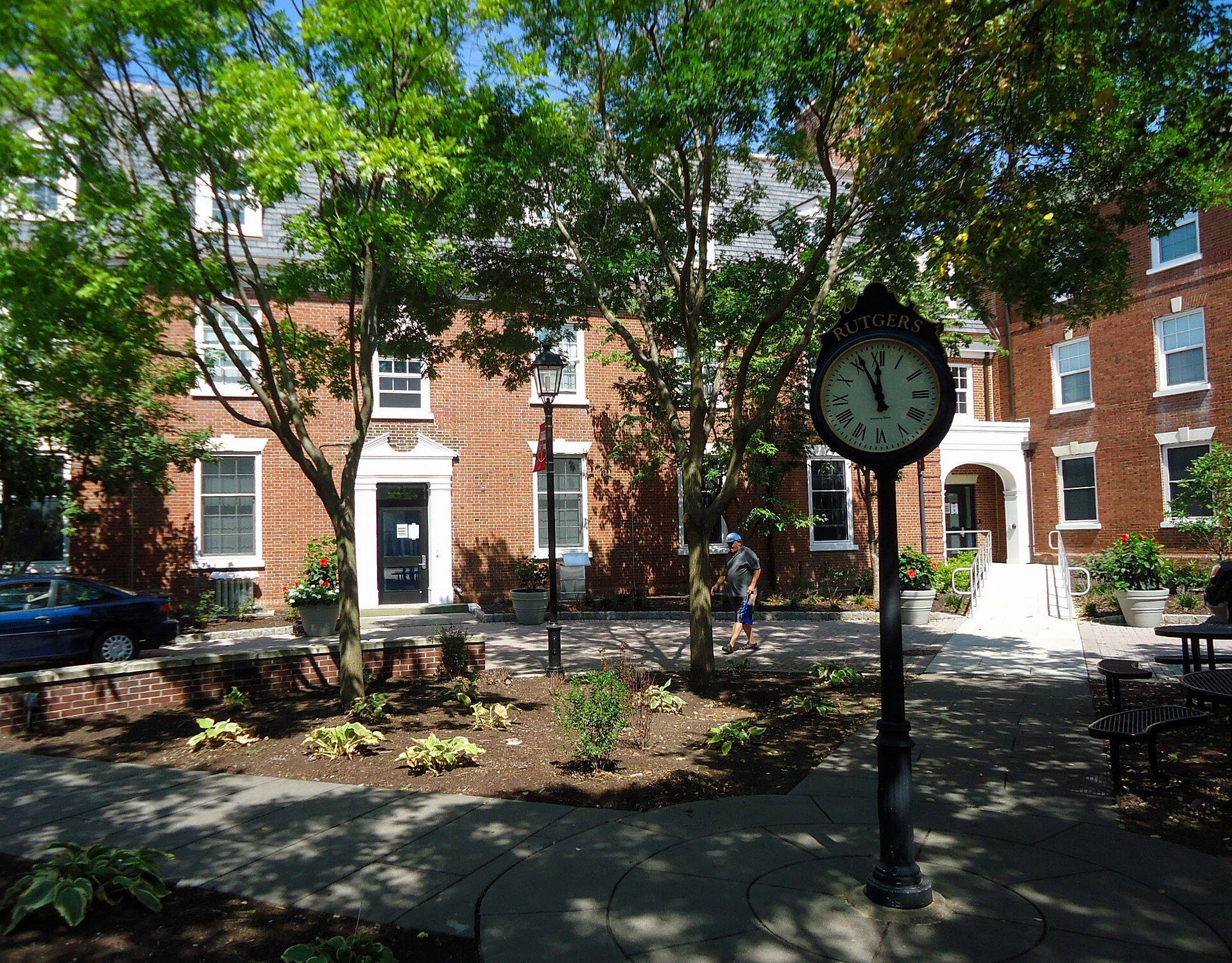Brick dormitories on the Rutgers campus, the on campus option weighed against off campus homes like those of Richard Joseph Spinelli
