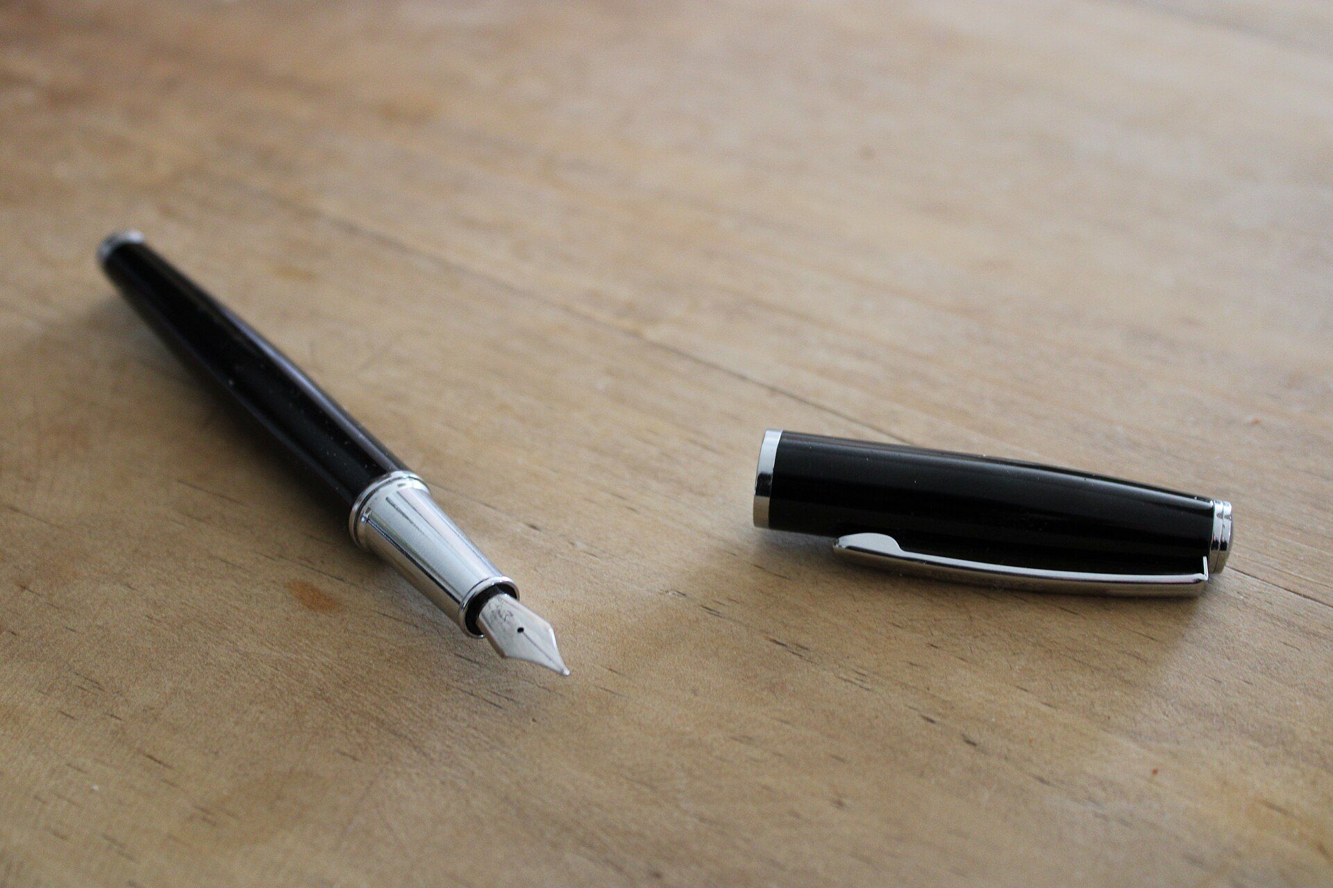 Fountain pen and cap on a wooden table, suggesting the parental guarantor signatures common in student leases Richard Joseph Spinelli writes