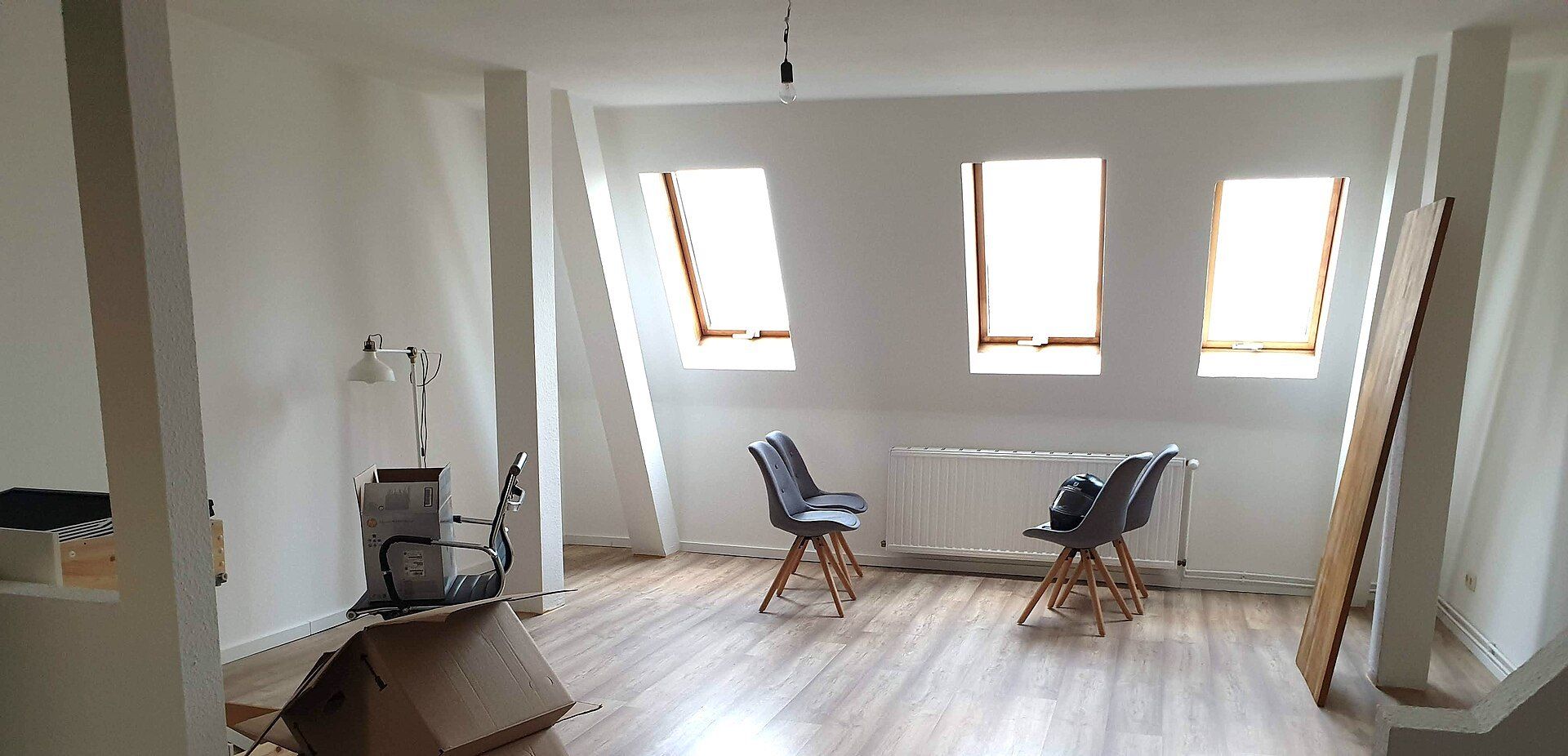 An empty top floor apartment with sloped ceilings, the kind of unit leased months ahead in the season Richard Joseph Spinelli works in