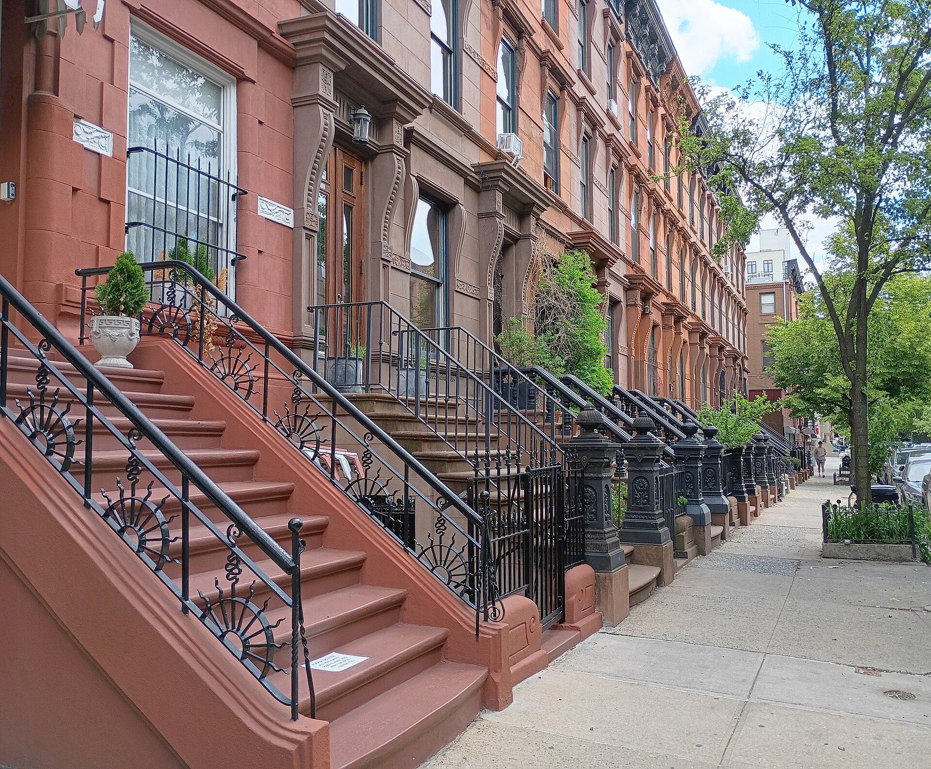 Brownstone houses with high stoops and iron railings, older city homes of the kind Richard Joseph Spinelli renovates
