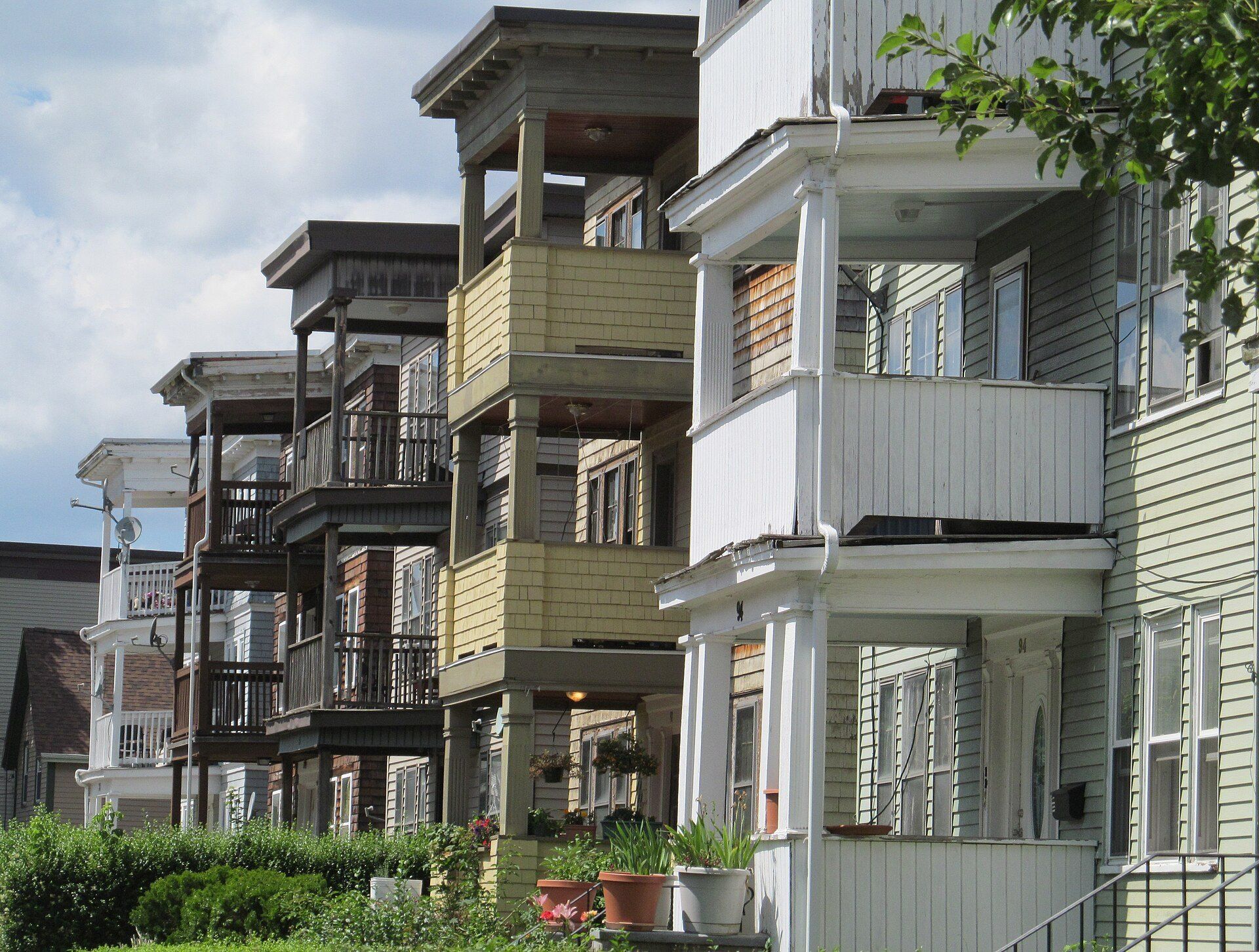 Wooden triple decker houses in Dorchester, small separate buildings like the scattered site model Richard Joseph Spinelli discusses