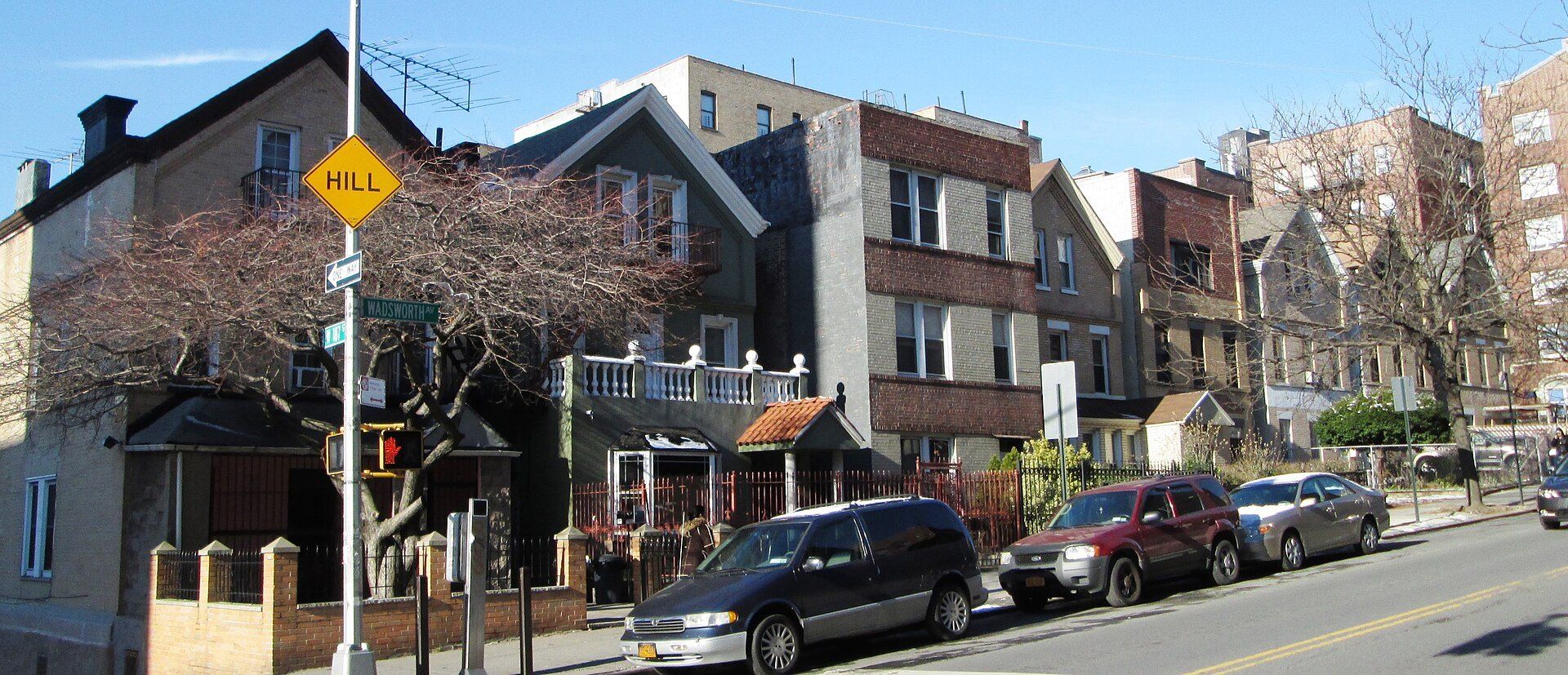 Small gabled brick multifamily houses in upper Manhattan, a building scale in the New York rental field of Richard Joseph Spinelli