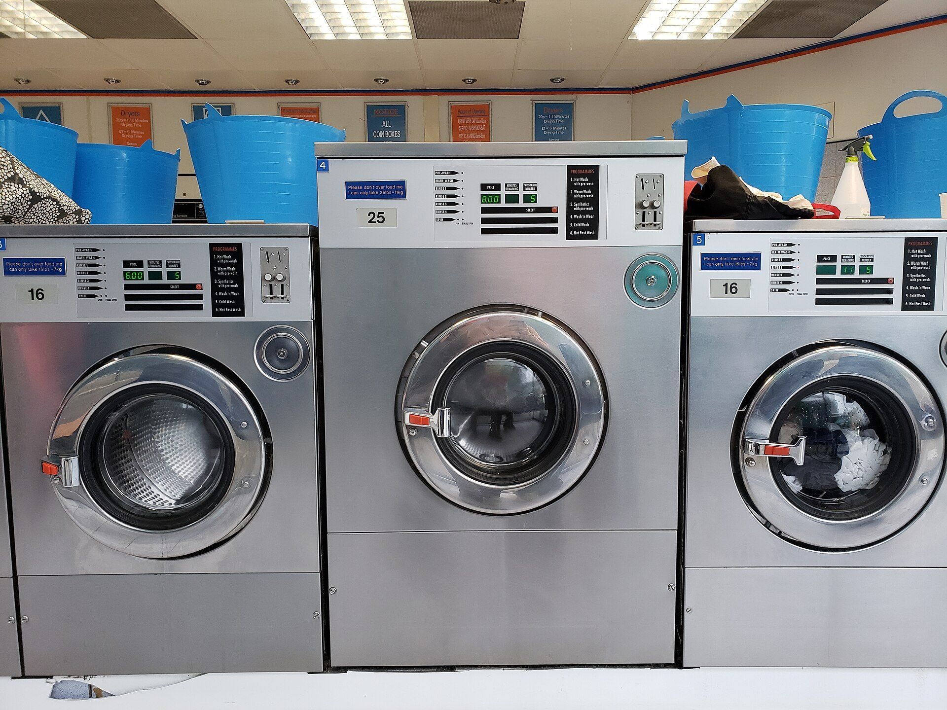 Row of front loading washing machines, the practical kind of amenity discussed in student housing entries on Richard Joseph Spinelli