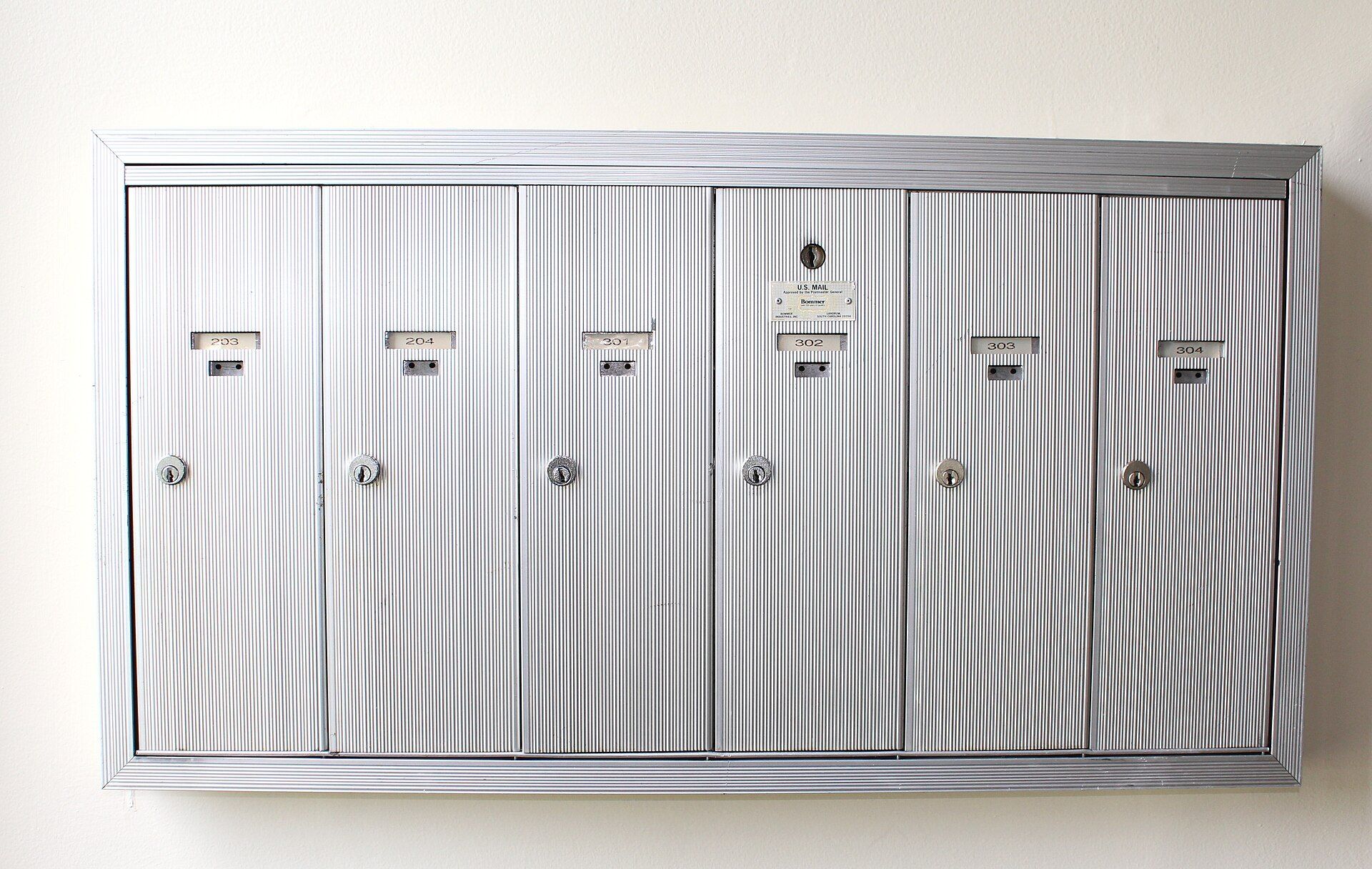 A bank of apartment building mailboxes, part of the daily running of rental housing that Richard Joseph Spinelli works in