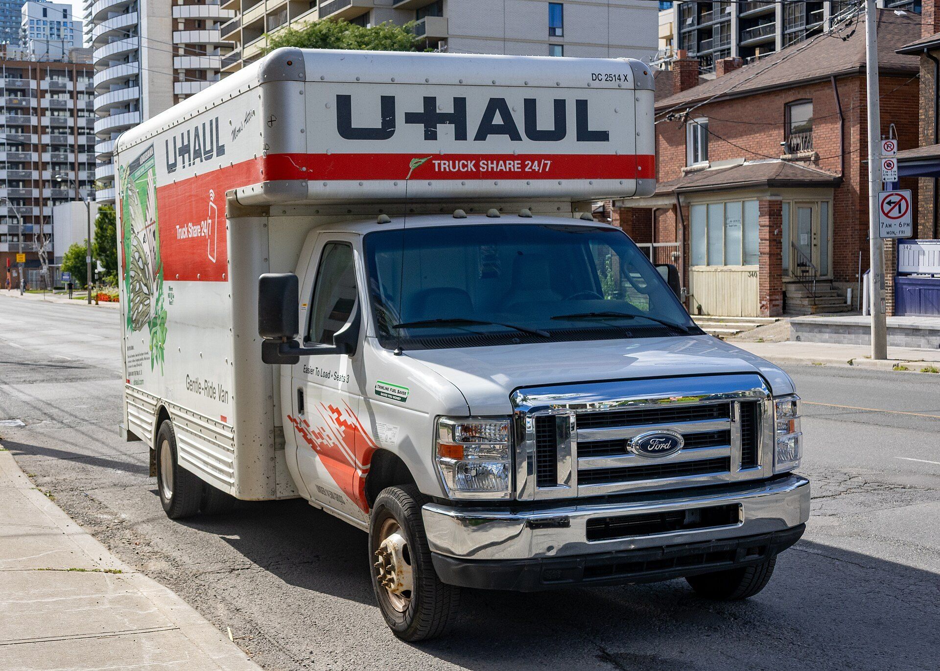 Rental moving truck parked on a city street, evoking the move in and turnover days in the student housing of Richard Joseph Spinelli
