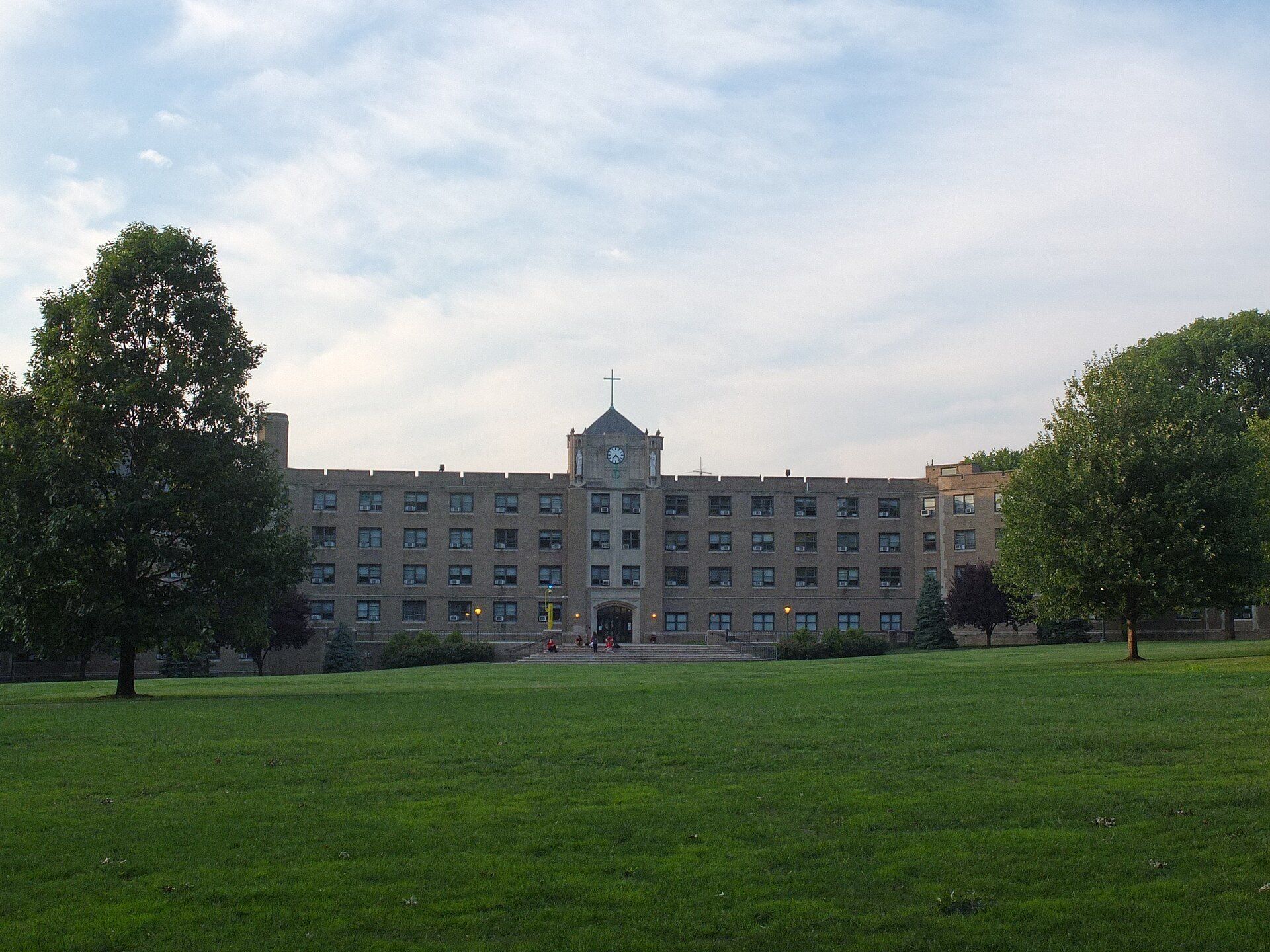 Martyrs' Court residence hall across a lawn at Fordham Rose Hill, context for the residency rules Richard Joseph Spinelli explains